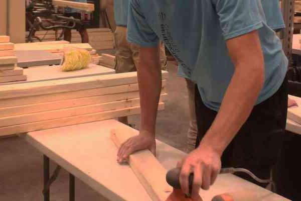 student working with wooden planks