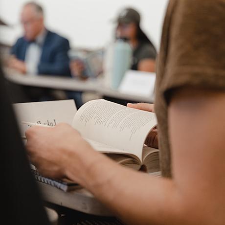 A student reads a book in a seminar class